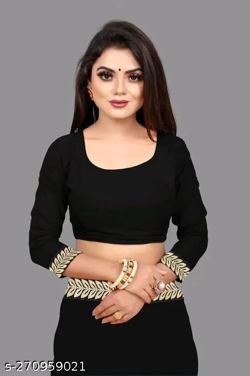Woman wearing a black designer blouse with golden embroidery on the sleeves and waist, posing with traditional jewellery.